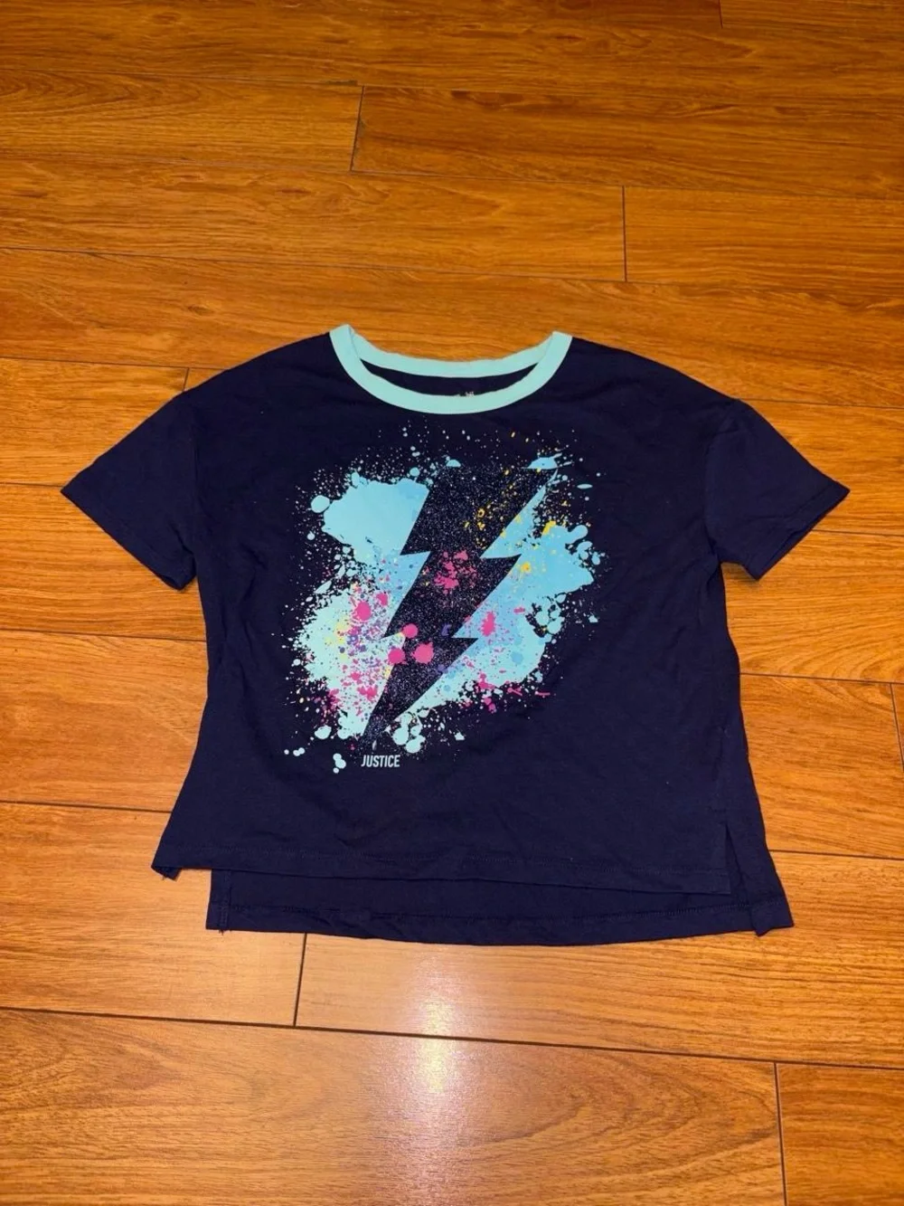 Y2K Justice navy blue tee with white lightning bolt graphic